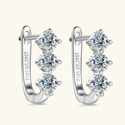 Three-stone moissanite huggie earrings in silver tone with three round stones
