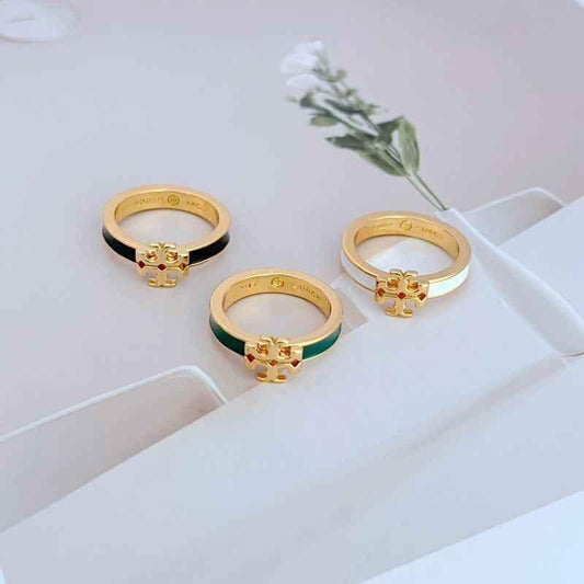 Set of three enamel rings with gold-tone bezels and green, white, and black bands