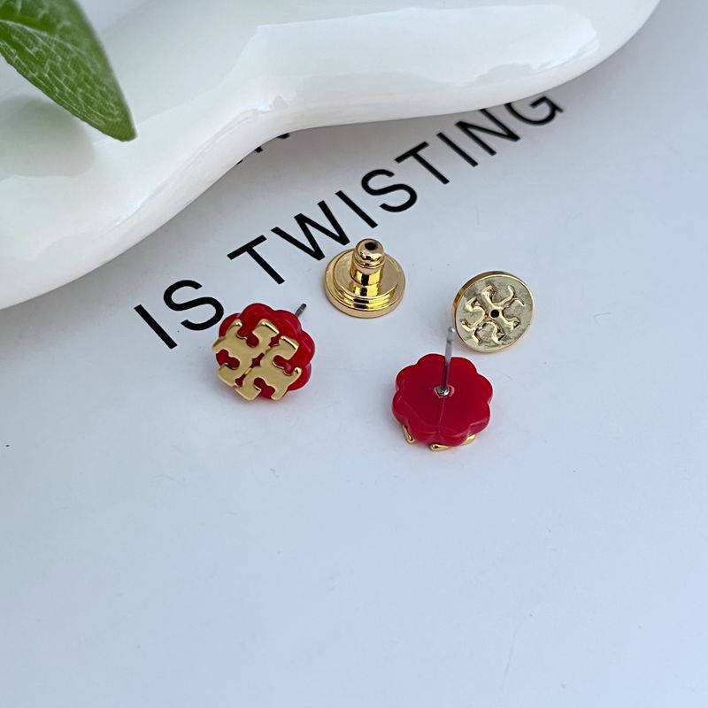 Red enamel logo stud earrings with gold-tone posts and butterfly backs