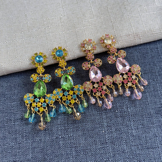 Long clip-on rhinestone tassel earrings, blue-green on left and pink on right