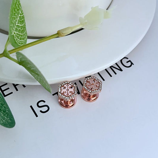 Rose gold hexagonal openwork metal stud earrings with pavé gems