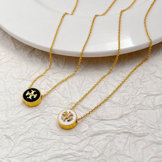 Gold-tone round enamel charm necklace with white logo medallion and fine chain links