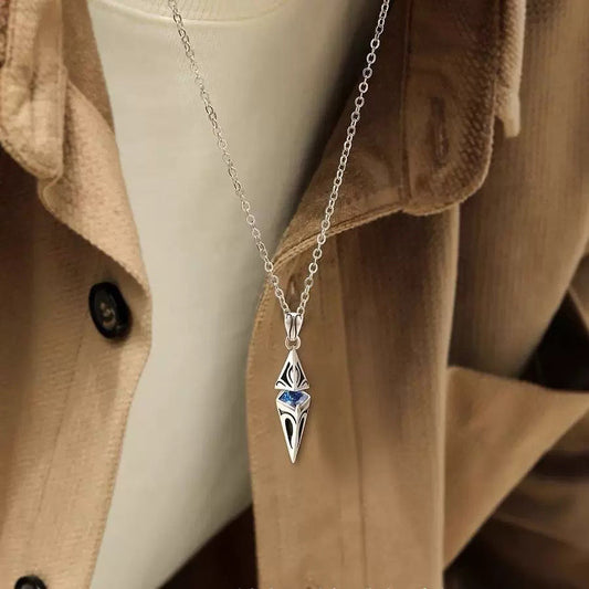 Necklace on model: silver sword pendant with blue gem on chain