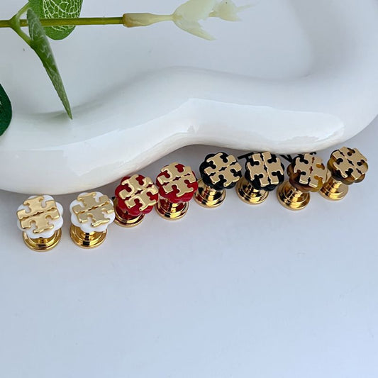 Mixed-color logo stud earrings: white, red, black, amber enamel with gold-tone posts