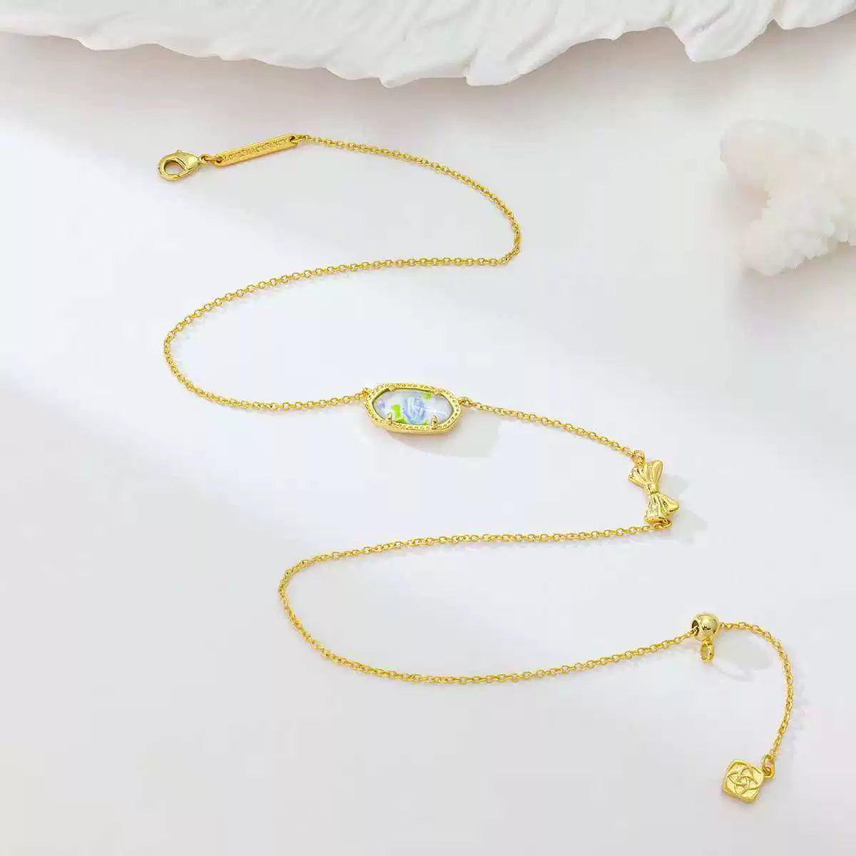Gold butterfly pendant necklace set with oval blue charm and butterfly links
