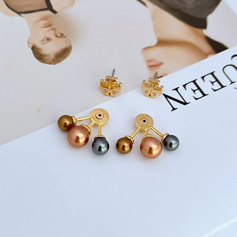 Gold-tone logo stud earrings with detachable metal-and-pearl drops in brown and gray