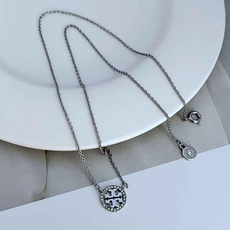 Silver-tone openwork pendant necklace with round diamond-studded charm disc and chain