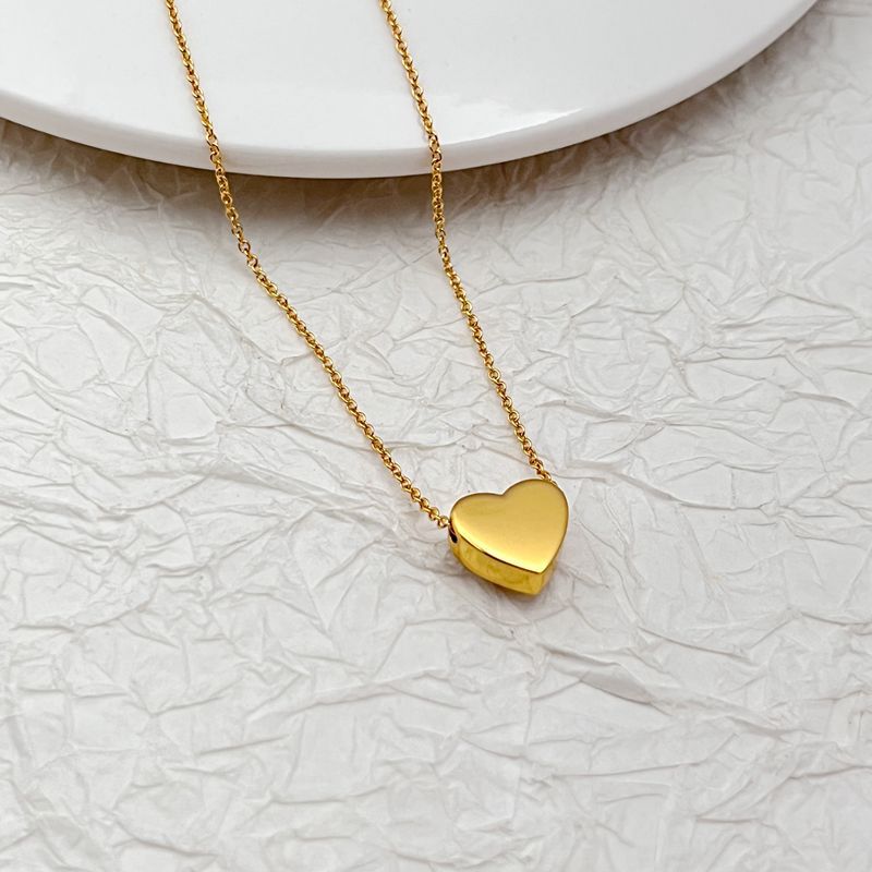 Gold-tone heart pendant necklace with smooth heart charm and cable chain