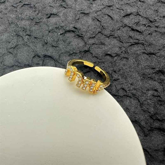Gold open ring with sparkling clear stones in an adjustable band