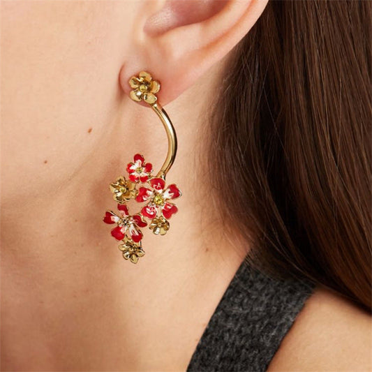 Gold hoop stud earrings with red enamel flower clusters and small gold accents