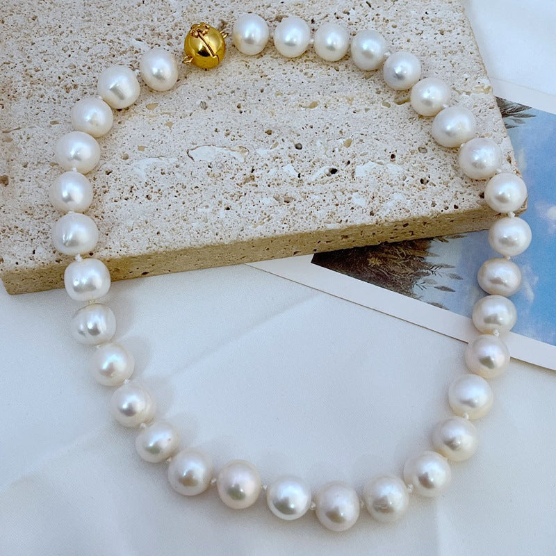 White pearl necklace with gold magnetic clasp and round pearl strand