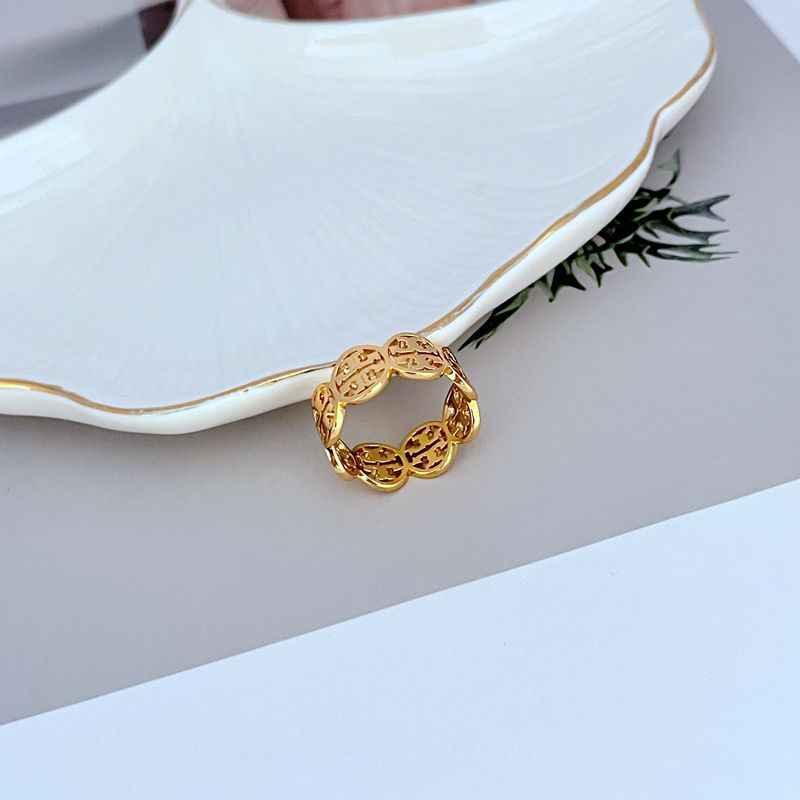 Openwork gold-tone metal ring with scalloped lattice links, circular shape