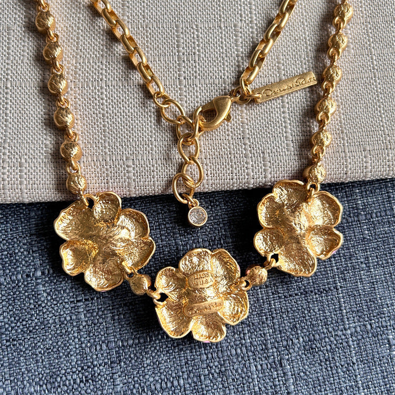 Gold-tone cherry blossom pendant necklace with five flower charms and chain