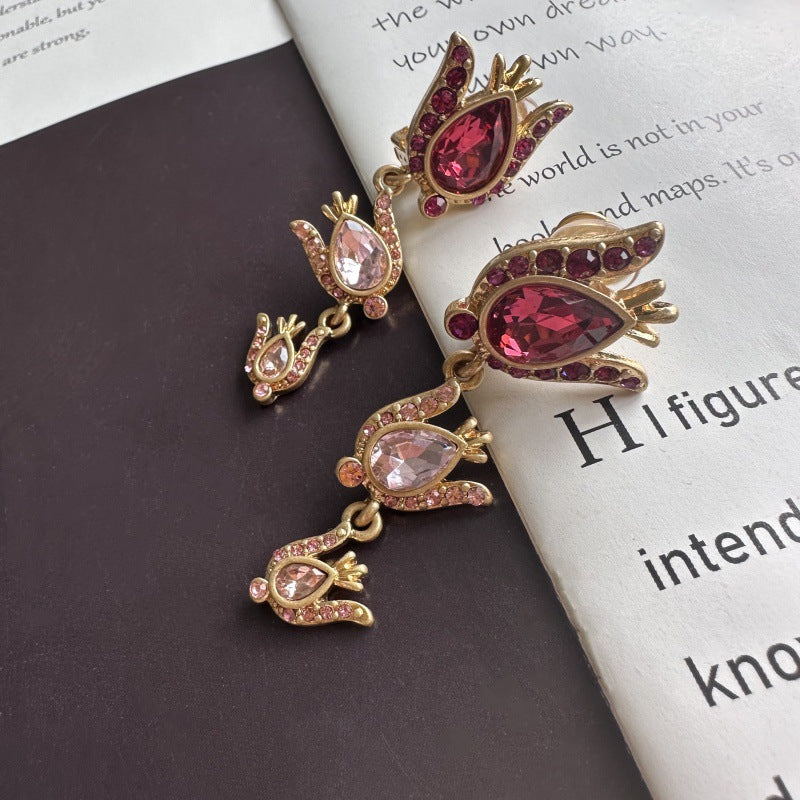 Gold-tone floral earrings with oval pink zircon stones and glittering clear accents