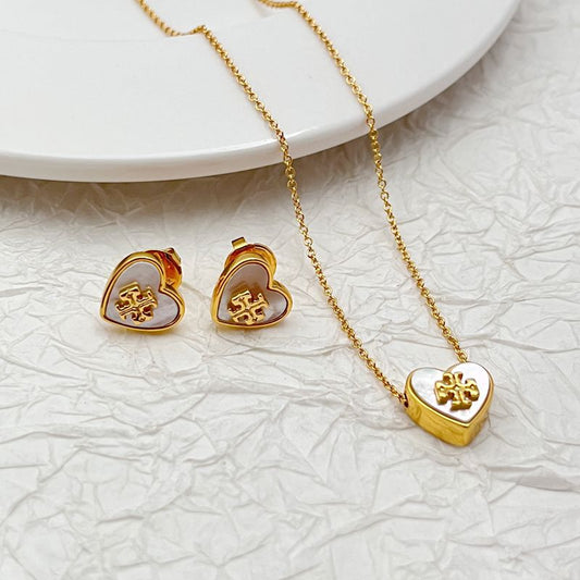Gold-tone heart stud earrings with logo inlaid and matching heart pendant necklace