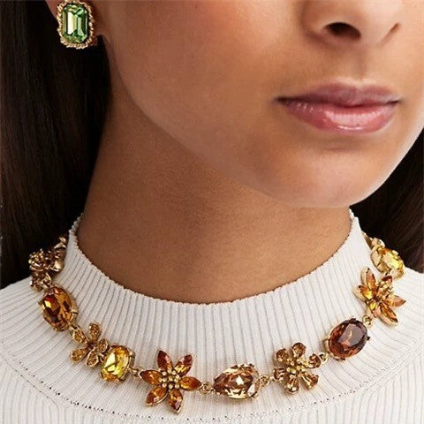 Gold-tone floral rhinestone necklace with green and amber faceted gemstone links