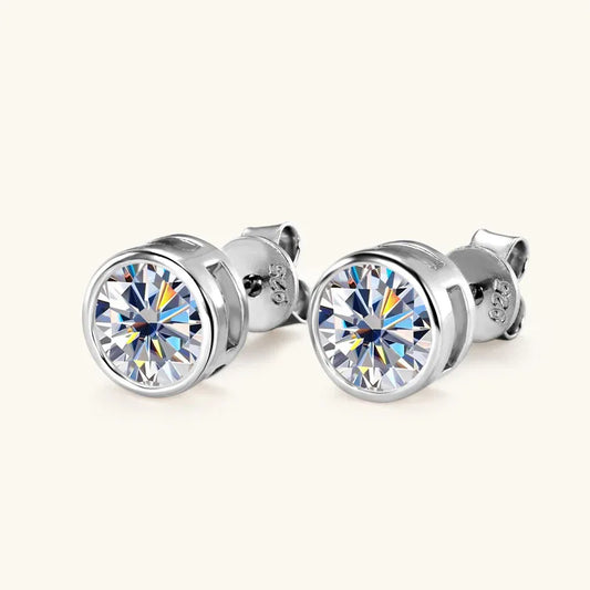 Round moissanite stud earrings in silver-tone metal with bezel setting and post backs