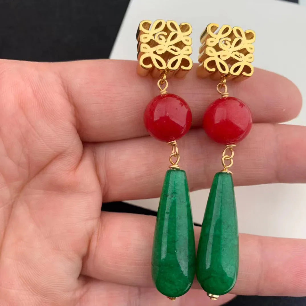 Vintage tassel teardrop agate earrings held in hand, gold caps, red spheres, green teardrops