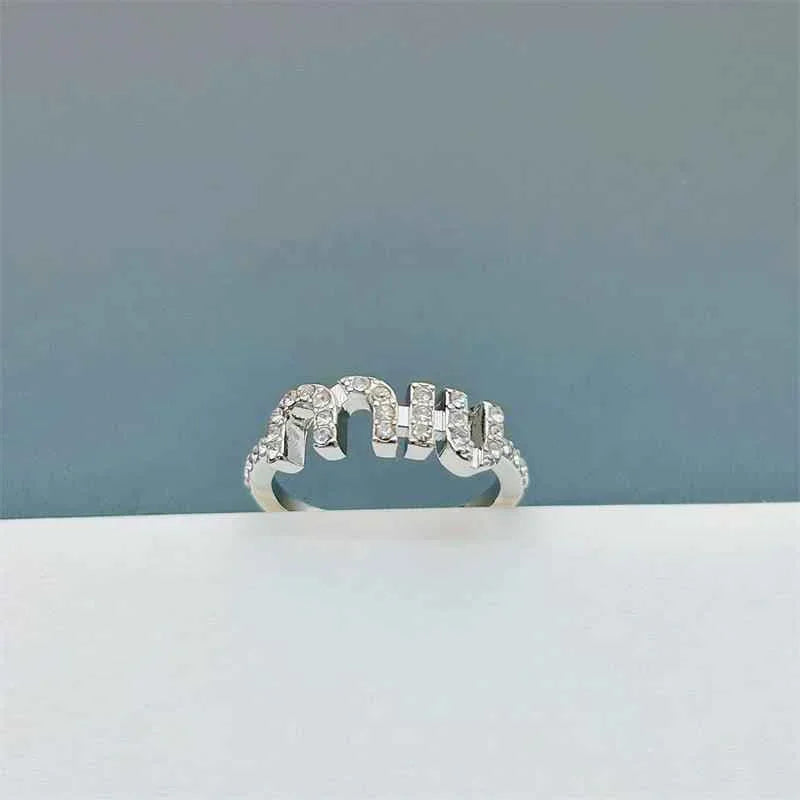 Gold open ring with bezel-set sparkling stones, adjustable band