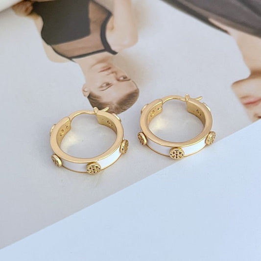 Gold-tone enamel logo hoop earrings with white enamel and logo charm accents