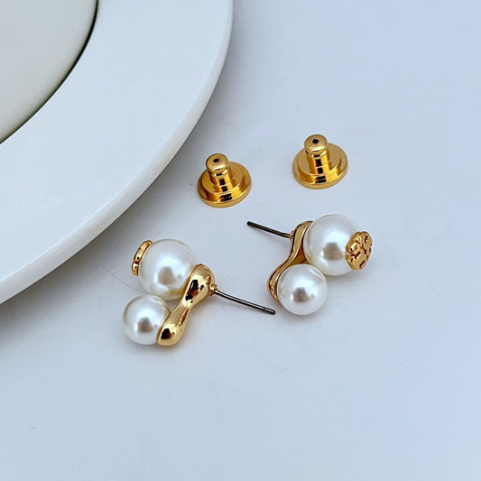 Pair of gold stud earrings with white pearl drops and logo cap details