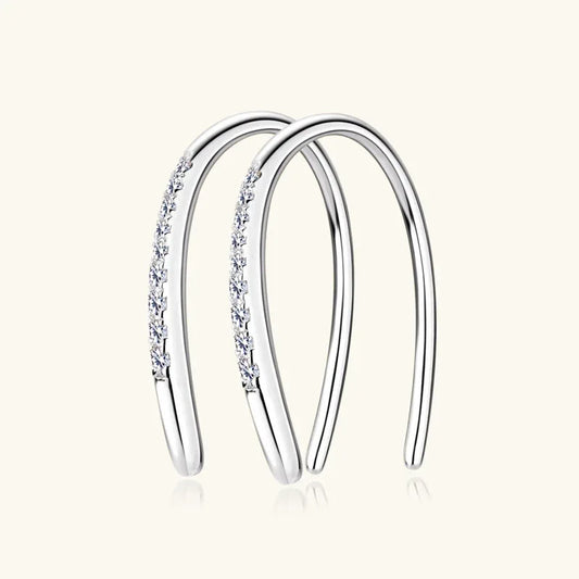 Silver-tone huggie hoop earrings with dangling row of small clear stones
