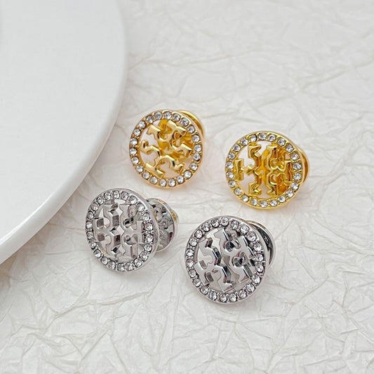 Tory Burch logo stud earrings set: gold-tone and silver-tone round discs with rhinestone rims