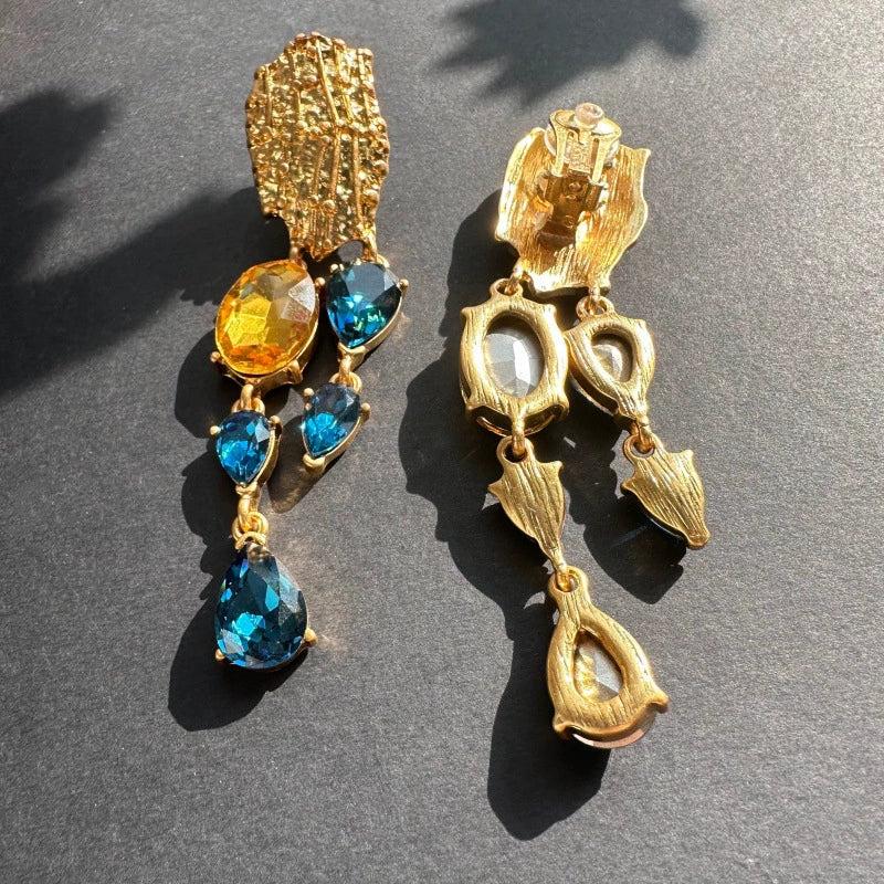 Crystal tassel earrings with gold textured studs and blue teardrop crystals with amber drops
