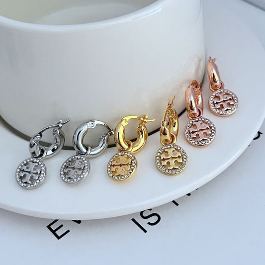 Assorted metal round pendant hoop earrings with pavé border and geometric cutout