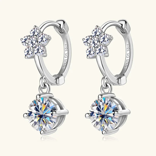 Silver hoop dangle earrings with four-stone flower top and a round moissanite drop