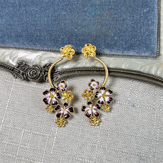 Gold hoop stud earrings with purple-and-pink enamel flower clusters and gold details