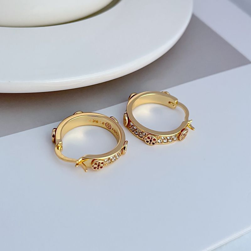 Gold hoop earrings with logo engraving, leopard enamel, and crystal accents on edges
