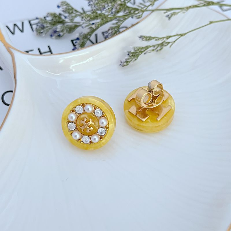 Gold-tone round stud earrings with pearl-and-crystal border; clasp backing shown