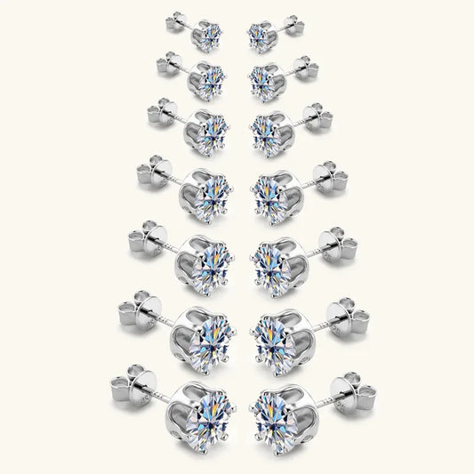 Silver-tone round stud earrings with clear center stones and butterfly backs