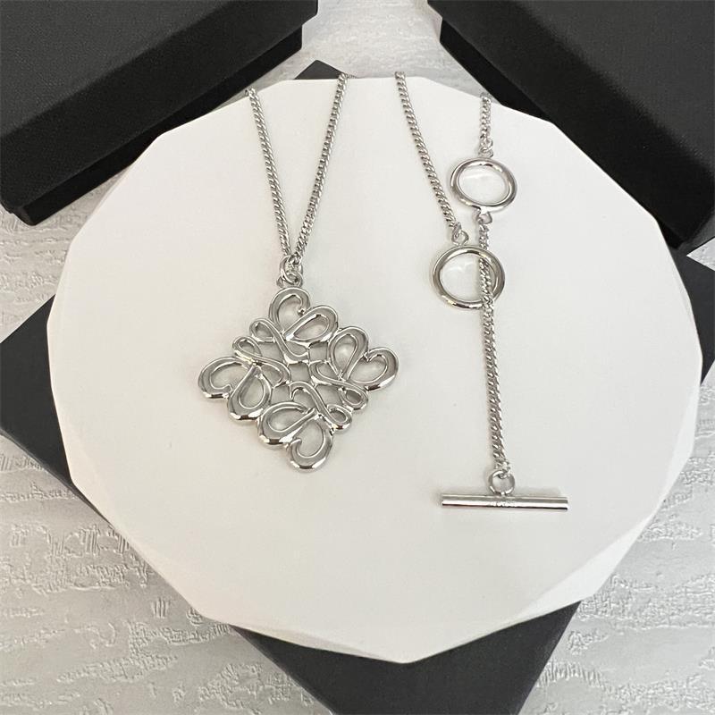 White gold hollow square design necklace with clustered pendant, ring accents, and bar charm