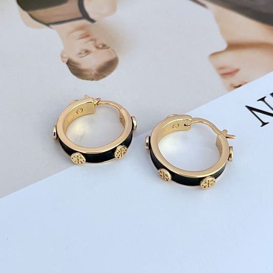 Gold-tone enamel logo hoop earrings with black enamel accents and logo studs