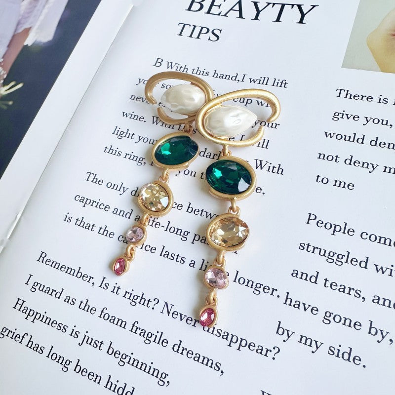 Oscar de la Renta long crystal drop earrings with green and purple faceted stones, gold tone.
