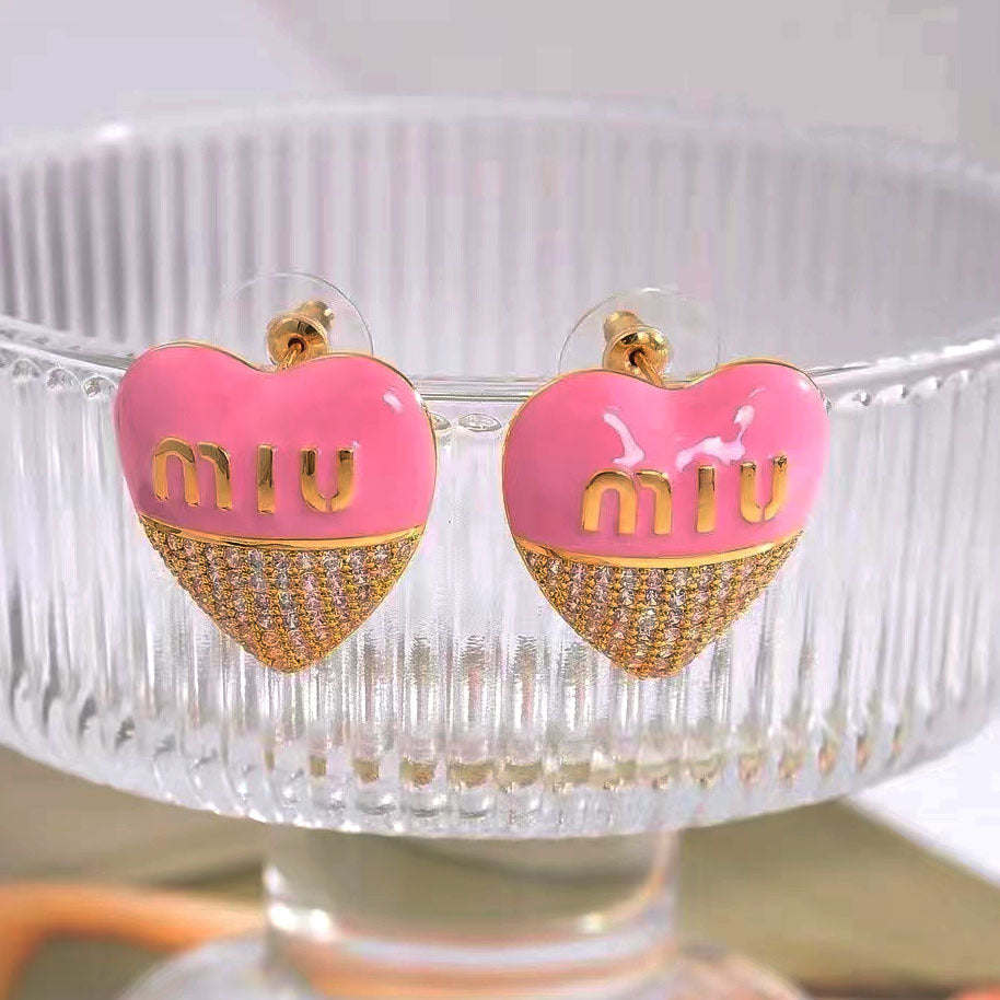 Heart stud earrings with pink enamel top and gold-tone pavé bottom