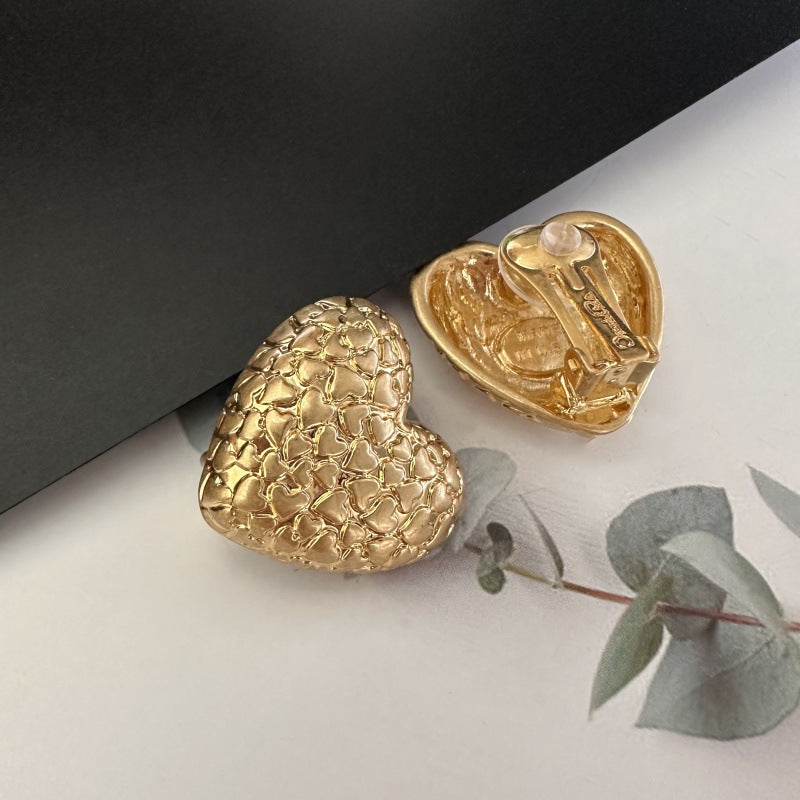 Gold heart clip-on earrings, textured vintage-print finish, front and back view