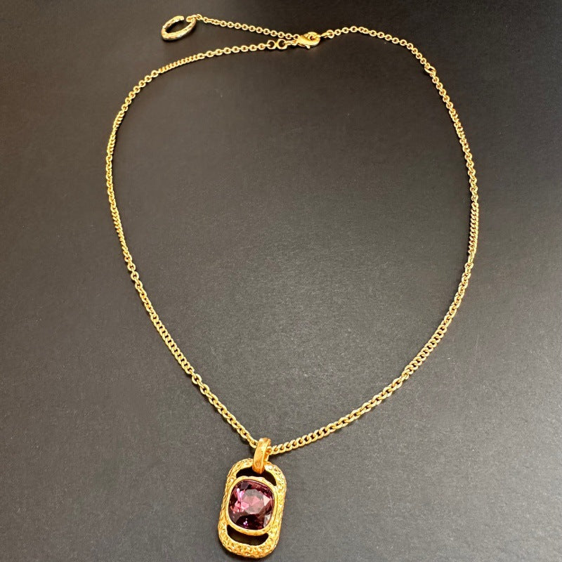 Gold chain square pendant necklace with hammered texture and pink faceted gem