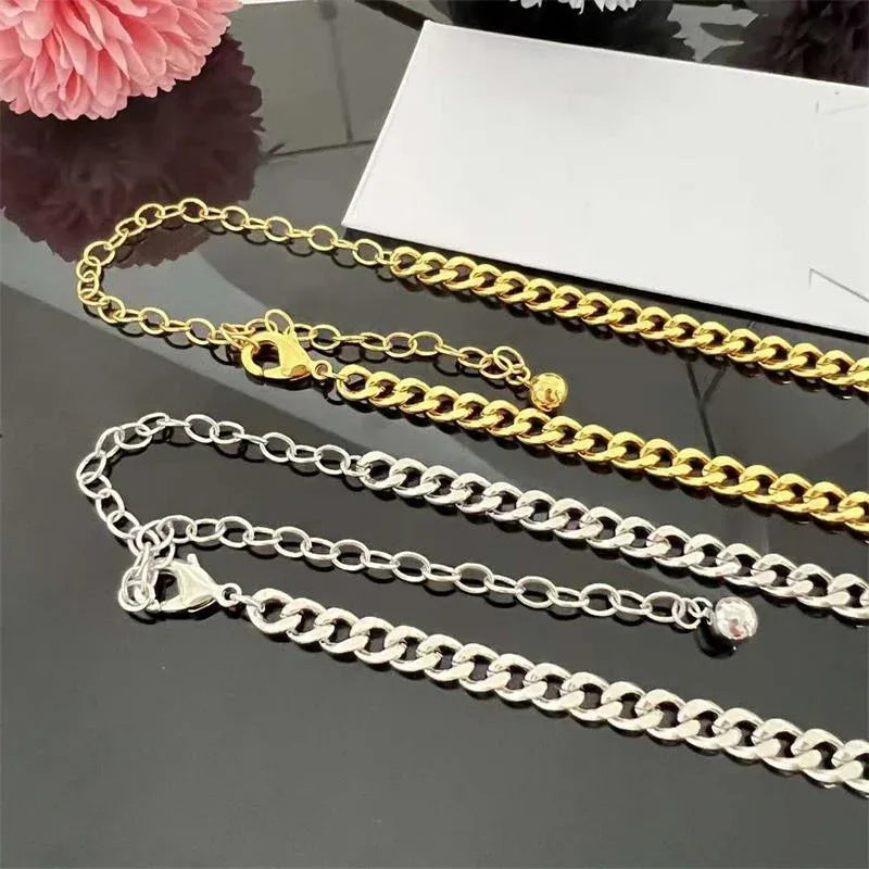 Gold and white gold Cuban link necklaces with heart-shaped charms and square pendant accents