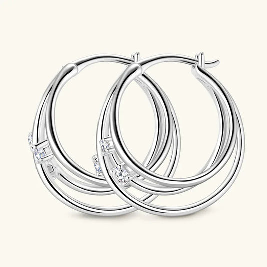 Silver layered hoop earrings with three rings and small round moissanite stones