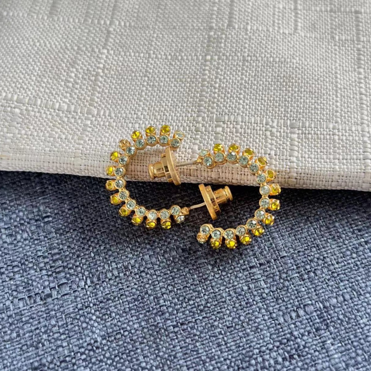 Gold-tone hoop earrings with yellow and blue cubic zirconia stones