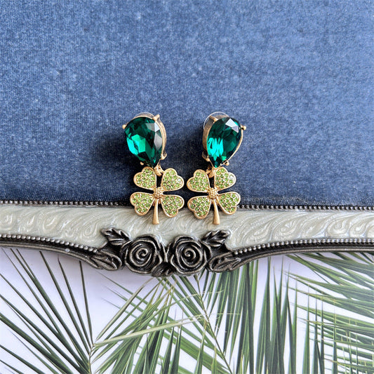 Vintage four-leaf clover drop earrings with green faceted stones and yellow pavé clovers