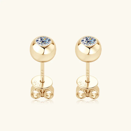 Gold moissanite stud earrings with round bezel-set stone and flat post backing