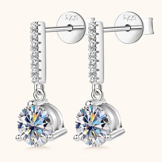 Silver three-prong moissanite drop earrings with round bezel-set stone and pave bar