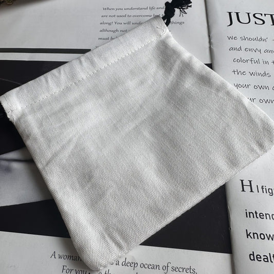 White packaging pouch with chevron texture and black tassel