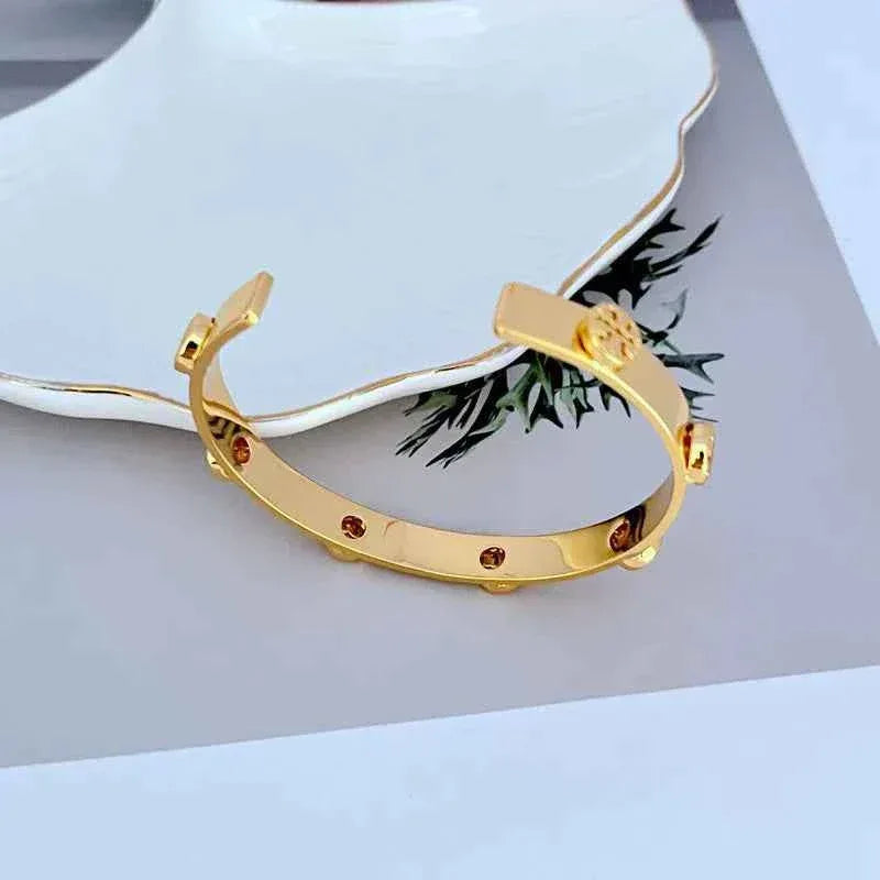Tory Burch Embossed Metal Open Bangle Gold Color - JIMMY JEWELRY 01