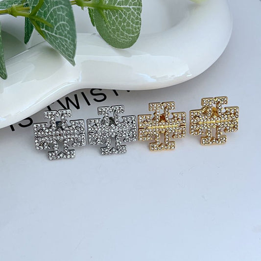Stud earrings in silver-tone and gold-tone: T-logo cross with diamond embellishment