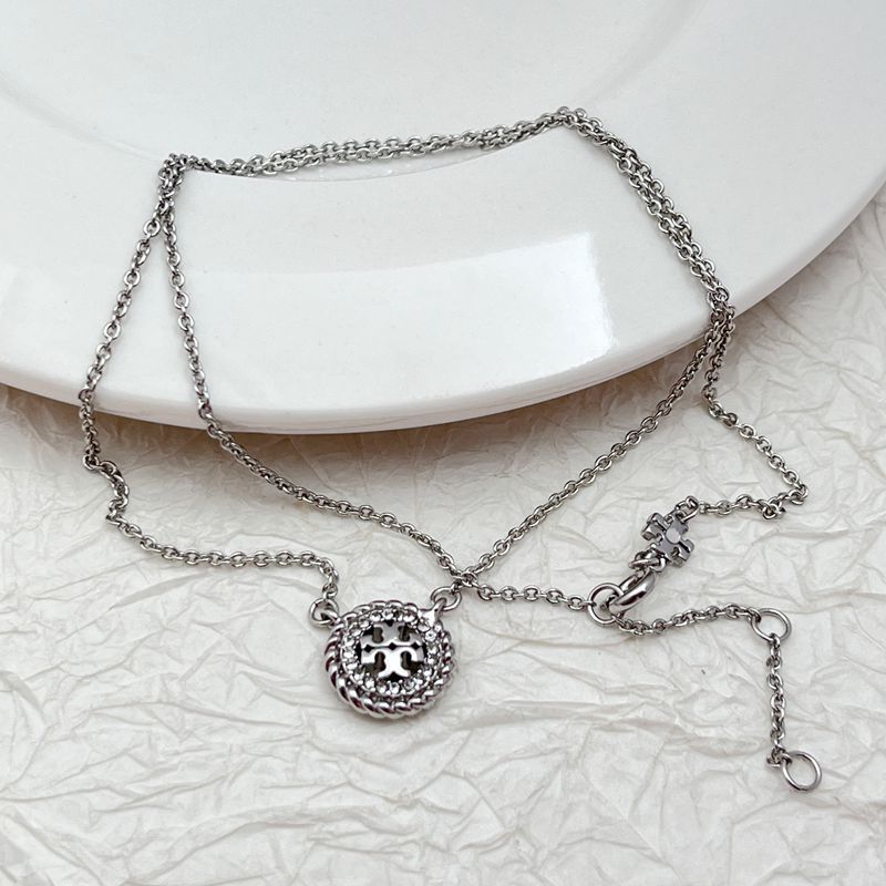 Silver-tone necklace with round openwork rhinestone pendant, clasp, and extender rings